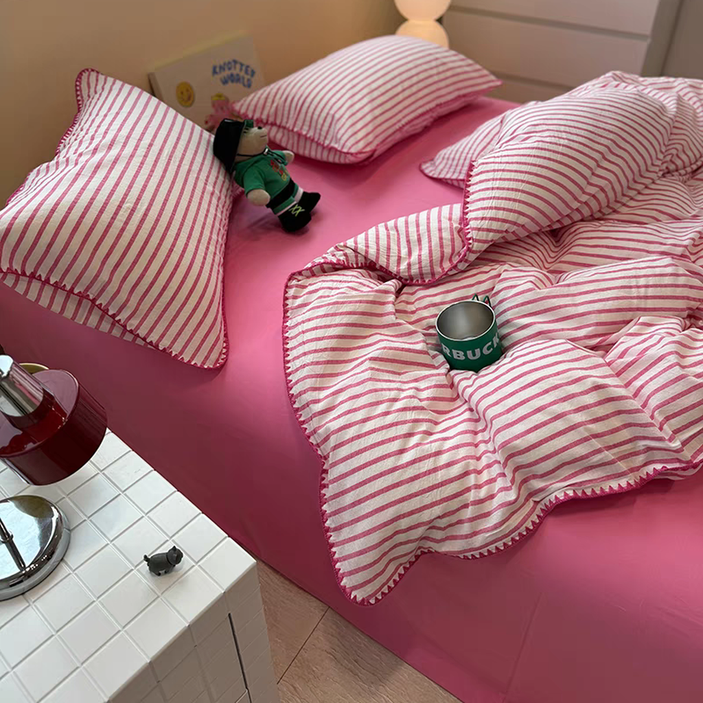Hot pink striped cotton bedding with a solid pink flat sheet