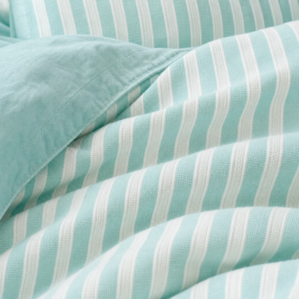Close-up of blue jacquard striped cotton bedding texture